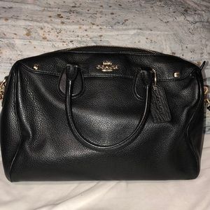 Black coach bag with gold accents and black strap